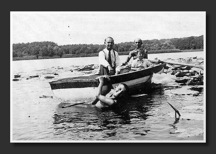 Cornell's dad, Emil, Uncle Stefan, and Cornell in the boat.  His brother, Ion,in the water at the lake at Snagov where the family were refugees during the war.